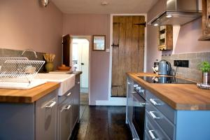 een keuken met een spoelbak en een aanrechtblad bij Finest Retreats - Flittermouse Cottage in Wingfield +13 foto's