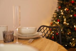 une table avec un bol et un sapin de Noël dans l'établissement L'Élégance – Cosy & Chill, à Chambéry