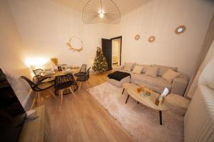 - un salon avec un canapé et un arbre de Noël dans l'établissement L'Élégance – Cosy & Chill, à Chambéry