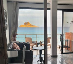 a living room with a view of the ocean at Dream View Nova in Rafrāf
