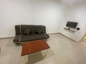 a living room with a couch and a coffee table at OYO 90497 Eva homestay in Kundasang