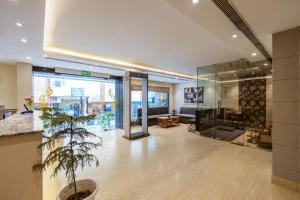 a lobby with a potted plant in a building at Hotel Mayur - New Delhi City Centre in New Delhi