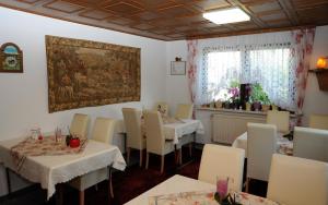 un ristorante con tavoli e sedie e un dipinto sul muro di Haus Stuttgart a Obernberg am Inn