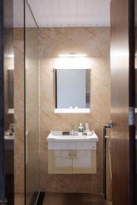 een badkamer met een wastafel en een spiegel bij Reunion De Homes - Premium Suites in Udupi