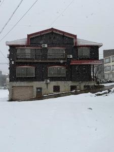 a building in the snow with snow at Nozawa Nest in Nozawa Onsen +18 photos