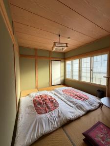 a room with a large bed in the corner at Nozawa Nest in Nozawa Onsen