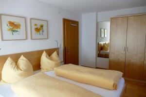 a bedroom with a bed with yellow pillows at Haus Lundegg in Finkenberg