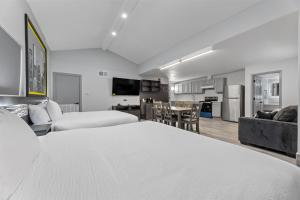 a living room with a bed and a dining room at Super 8 by Wyndham Texas City in Texas City