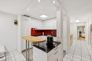 a kitchen with white cabinets and a wooden counter top at Marlin Home in Ipsach