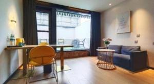 a living room with a couch and a table at Magnotel Shenyang Consulate Qingnian Street in Shenyang