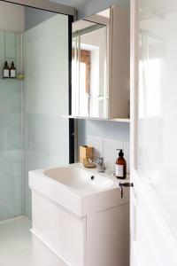 a bathroom with a white sink and a mirror at L'Auberge des Clés in Chevannes +54 photos