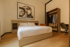 a bedroom with a large bed and a closet at Cavour Suites in Ancona