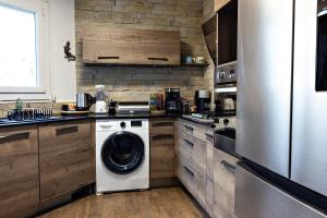 a kitchen with a washing machine and a washer at splendide in Chalon-sur-Saône