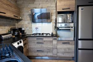 a kitchen with a stove and a refrigerator at splendide in Chalon-sur-Saône +3 photos