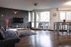 a living room with a couch and a table at splendide in Chalon-sur-Saône