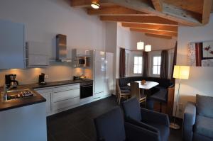 a kitchen with a table and chairs in a room at Chalet an der Piste in Kaprun