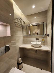 a bathroom with a sink and a mirror at Hotel JK Palace Newly Renovate in Shirdi