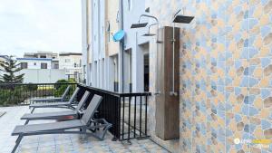 a row of chairs sitting on a balcony at Chic studio with parking and pool in Douala