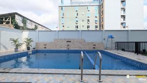 a swimming pool on the roof of a building at Chic studio with parking and pool in Douala