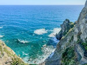 a view of the ocean from a cliff at Il Sogno di Beatrice Luxury Apartment with Views in Manarola