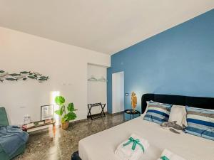 a bedroom with a large bed with a blue wall at Il Sogno di Beatrice Luxury Apartment with Views in Manarola