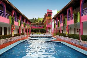 a swimming pool in the middle of a building at Decameron Los Cocos - All Inclusive in Rincon de Guayabitos