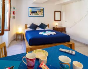 a bedroom with a bed and two tables with cups at Ventu de Ma Studios & Rooms in Vernazza