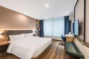 Postel nebo postele na pokoji v ubytování 7 Days Inn Xiangtan Erqiao Fenghuang East Road 1st County High School + 141 fotografií