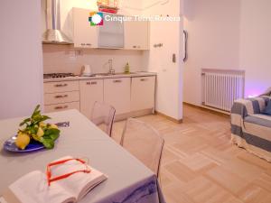 a kitchen with a white table and chairs in a room at Casa Pina Family Apartment in Vernazza +15 photos