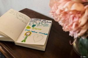 a book sitting on a table next to a flower at Mainetta Sea View Apartment with AC in Vernazza