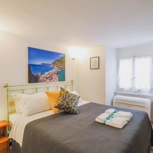 a bedroom with a bed with two towels on it at Mainetta Sea View Apartment with AC in Vernazza