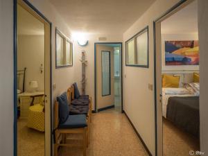 a bedroom with a bed and a chair and a mirror at Mainetta Sea View Apartment with AC in Vernazza