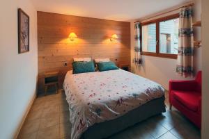 a bedroom with a bed and a red chair at Gîte Les Neufs Lieux in Gérardmer +32 photos