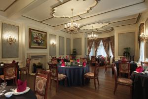 a dining room with tables and chairs and a chandelier at Villa Morriss Residence - D'CONG Heritage in Shanghai