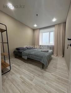 a bedroom with a bed and a window at Boroboye, Burabay, Kazakhstan in Borovoye