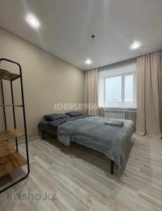 a bedroom with a bed and a large window at Boroboye, Burabay, Kazakhstan in Borovoye