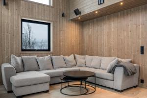 a living room with a couch and a table at GO-34B Large family cabin in Trysil next to the Gondole in Trysil
