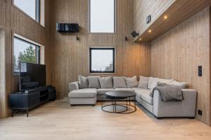 a living room with a couch and a tv at GO-34B Large family cabin in Trysil next to the Gondole in Trysil