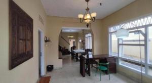a dining room and living room with a table and chairs at Arwana Inn in Bandar Lampung