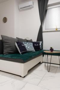 a couch with pillows on it in a room at Luxury Apartment Brendi in Log pri Brezovici