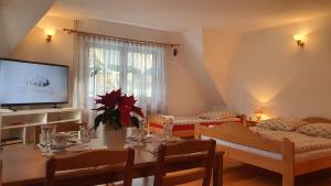 a living room with a table and a television at Villa Poronianka in Poronin