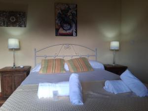 a bedroom with a white bed with two lamps at R2R - Ático con encanto Colindres - C08A01 in Colindres