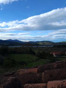 a view of a green field with mountains in the distance at R2R - Ático con encanto Colindres - C08B01 in Colindres