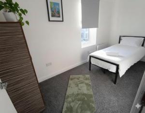 a bedroom with a bed and a table and a mirror at Esk View House,Carlisle in Carlisle