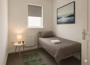 a small bedroom with a bed and a window at Esk View House,Carlisle in Carlisle