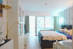 a hotel room with a bed and a window at Seehütte 004 in Cuxhaven