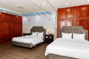 Postel nebo postele na pokoji v ubytování Khánh Ly Hotel - 庆丽酒店