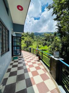 a view of a balcony of a house with a red frisbee at Shree Kedar dham Guest House in Gupta Kāshi