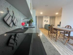 a kitchen and living room with a table and chairs at Casa do Barbosa in Monção