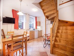 a kitchen and dining room with a dining table and a staircase at Nová Hájovna in Říčky +44 photos